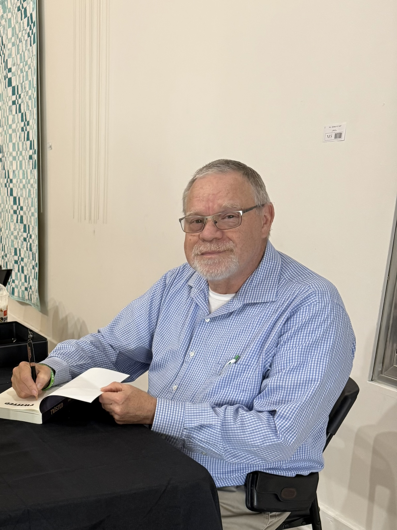 older white man signing book Terry Cavanaugh Ohio author